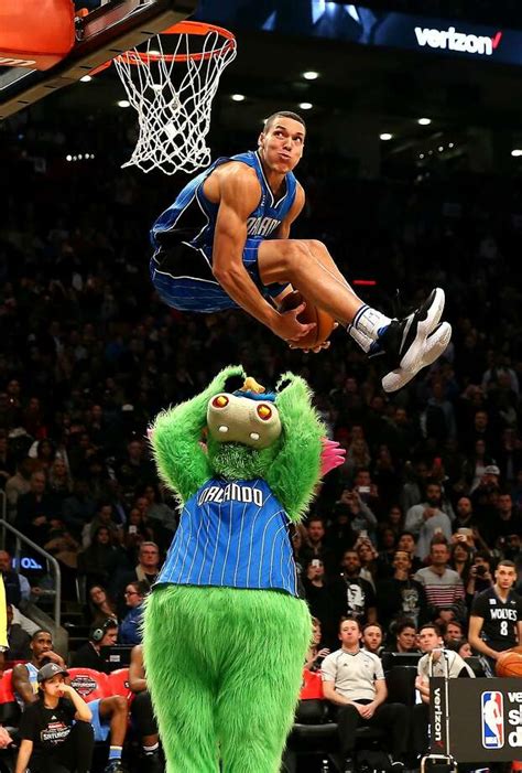Aaron Gordon soaring over a mascot for a dunk